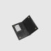 Black leather wallet on a light gray background