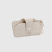 Quilted beige phone case with a chain on a light gray background